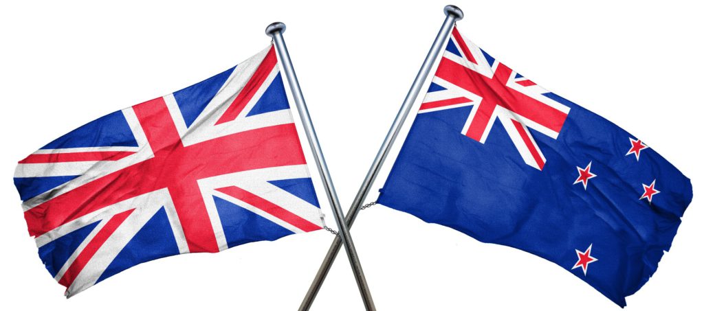 Two flag poles of the Great Britain flag and New Zealand flag crossing over. 