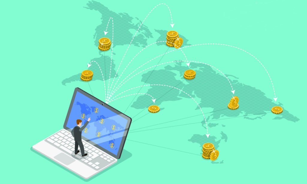 Graphic that shows a person standing on a laptop with a map of the world behind it. Various arrows pointing to different destinations where there are piles of currency coins. Depicting sending money internationally. 