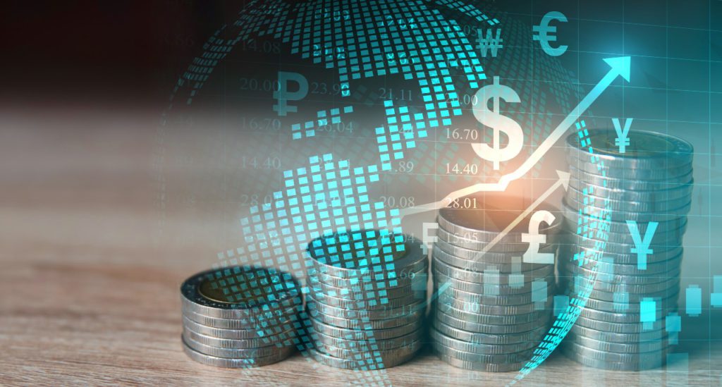 Currency coins stacked up with an overlay of the world, currency symbols and arrows pointing up to show fluctuations in rates.