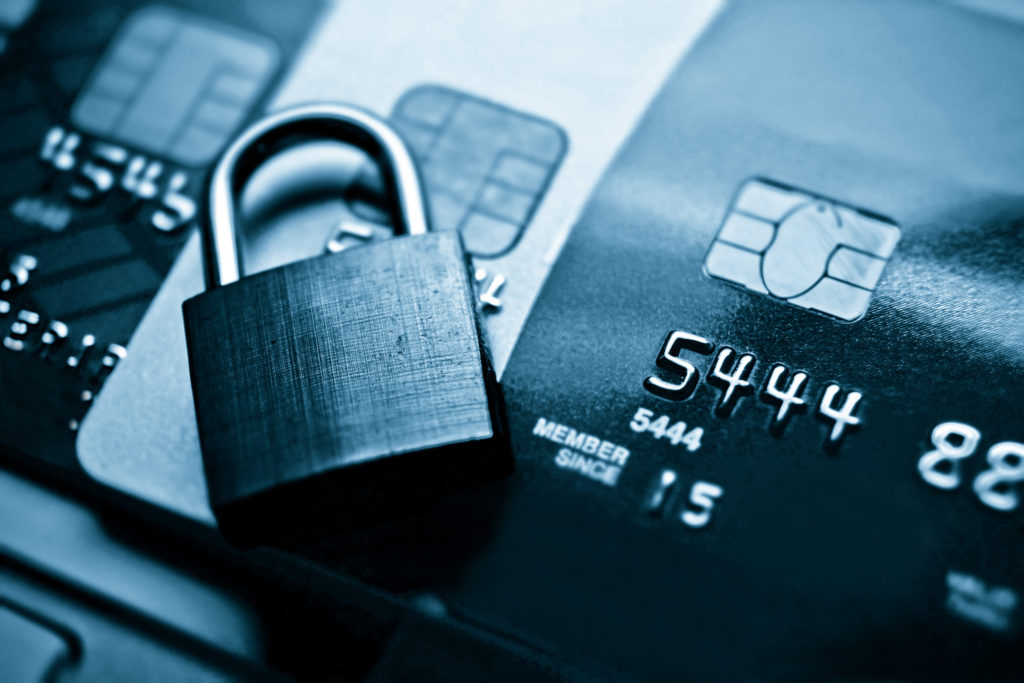 Black and white image of a padlock on top of credit cards. Secure international money transfers is important. 