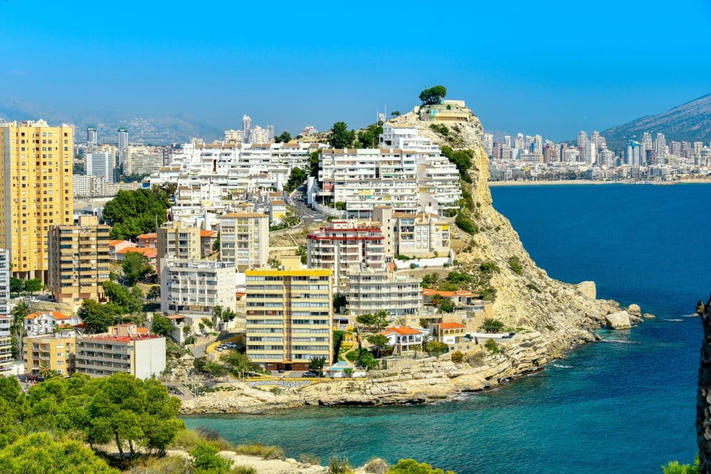 properties and buildings on the coast of Finestrat in Spain on a sunny day near the sea.