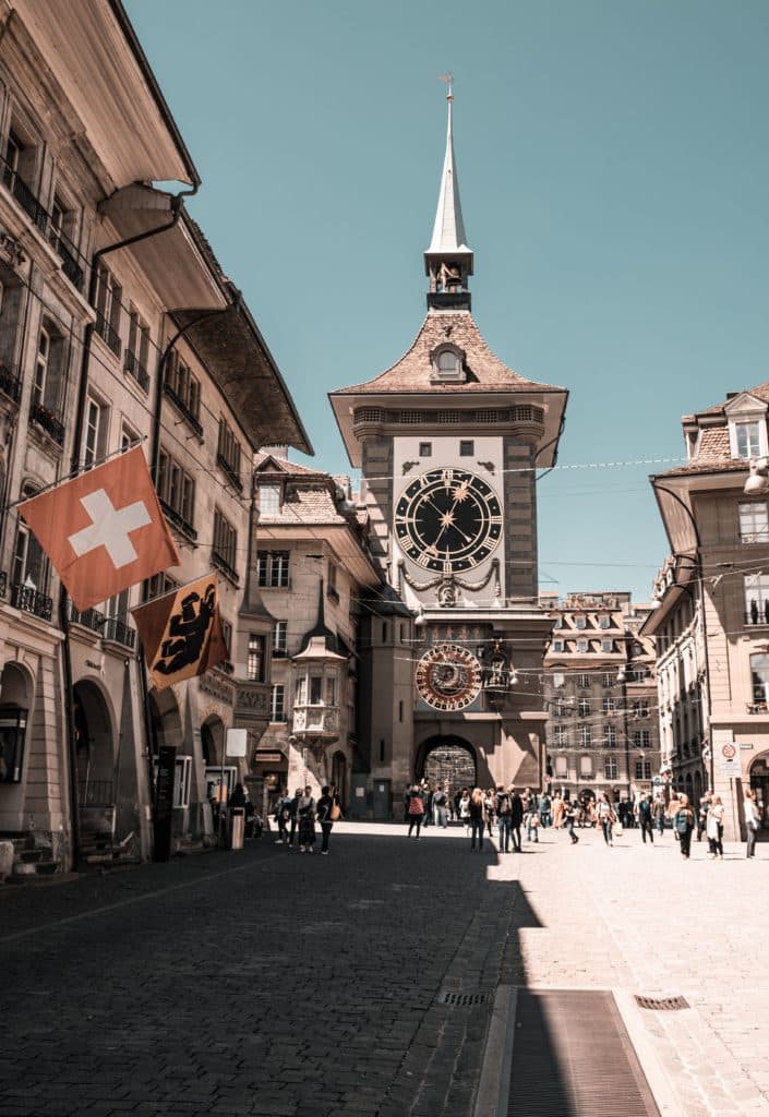 photo taken of a clock tower during the day in Bern, Switzerland.