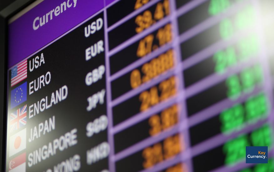 Close up photo of an exchange rate forecast board showing multiple currencies and their rates vs other currencies. 