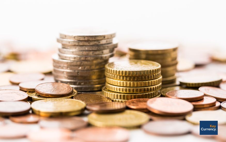 A pile of different euro coins stacked and scattered together. 