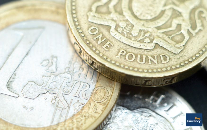 a one-pound coin placed slightly on top of a one-euro coin. Symbolising the pound to euro rate.