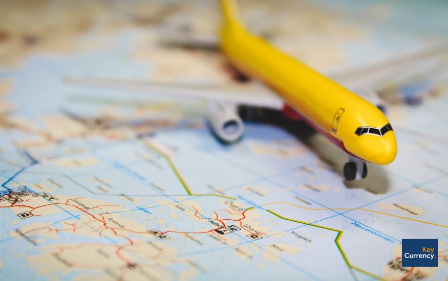 A yellow toy plane on a map.