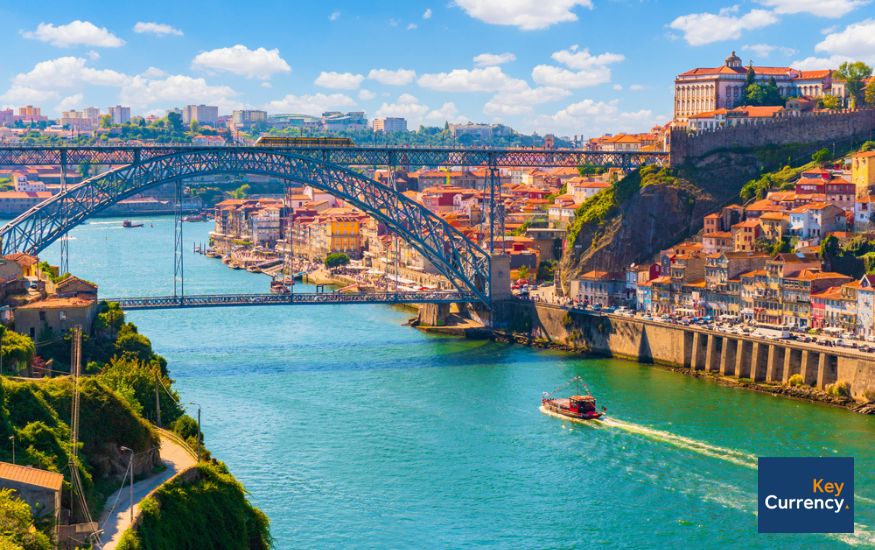 Photograph of bridge in Porto, Portugal, on a warm sunny day. 