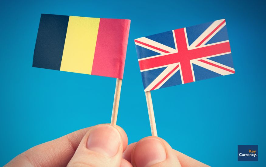 Person holding the flag of Belgium and the UK. 